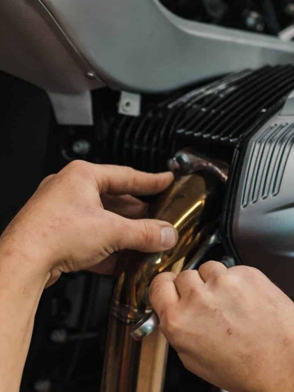 Repairman repair motorcycle, maintenance in garage. Mechanic fixing bike in a modern shop